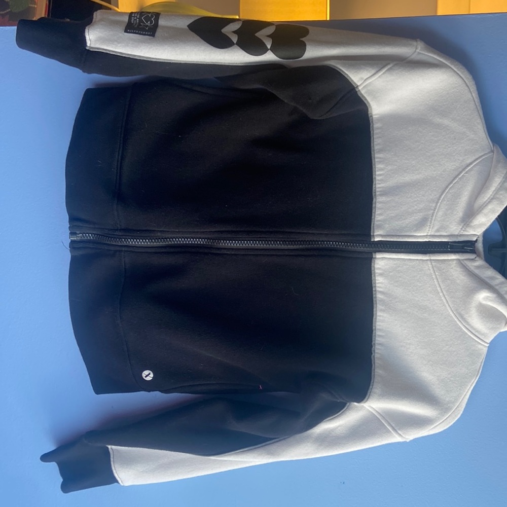 A zip up jacket, black, and white